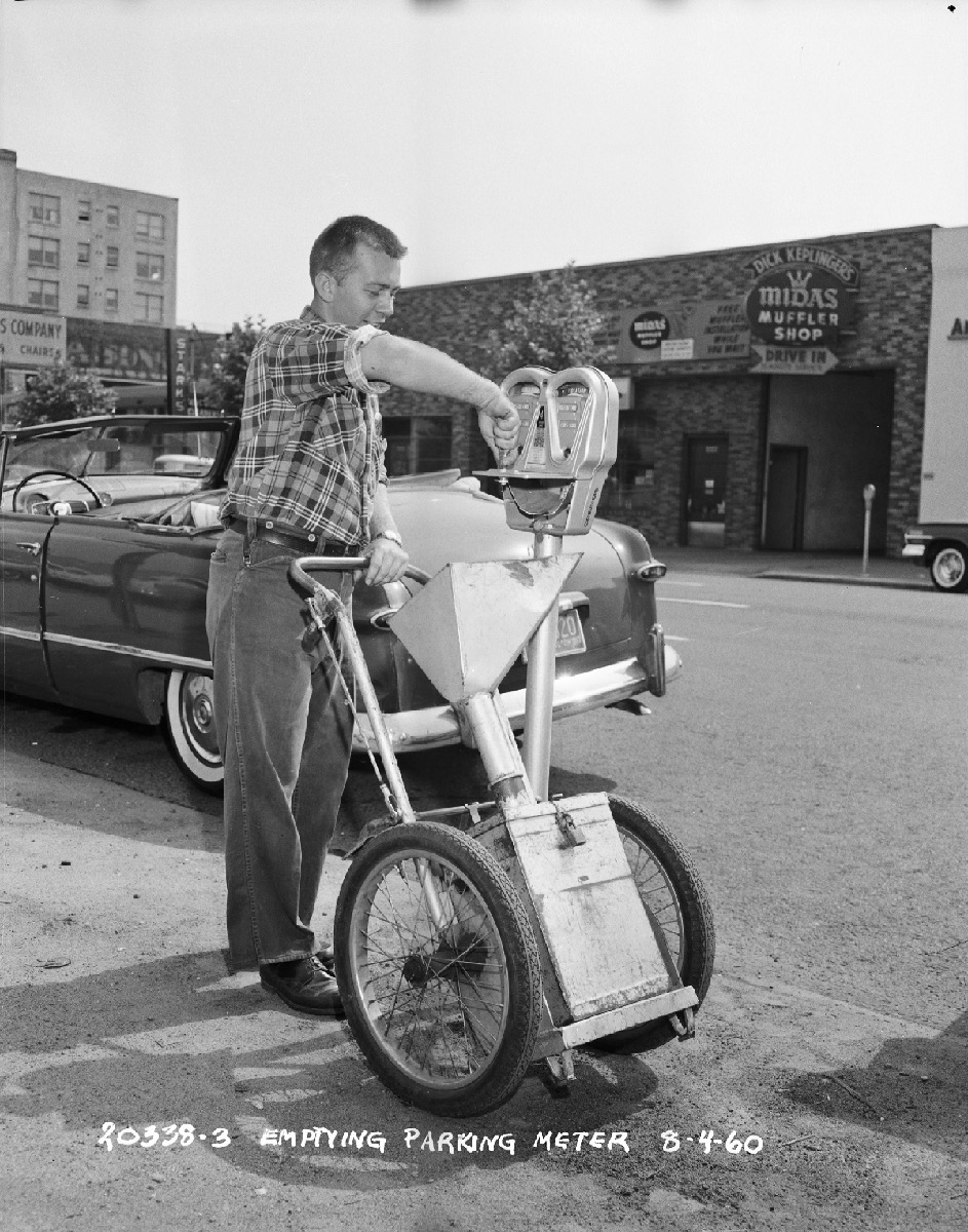 A Seattle municipal worker servicing a parking meter in 1960