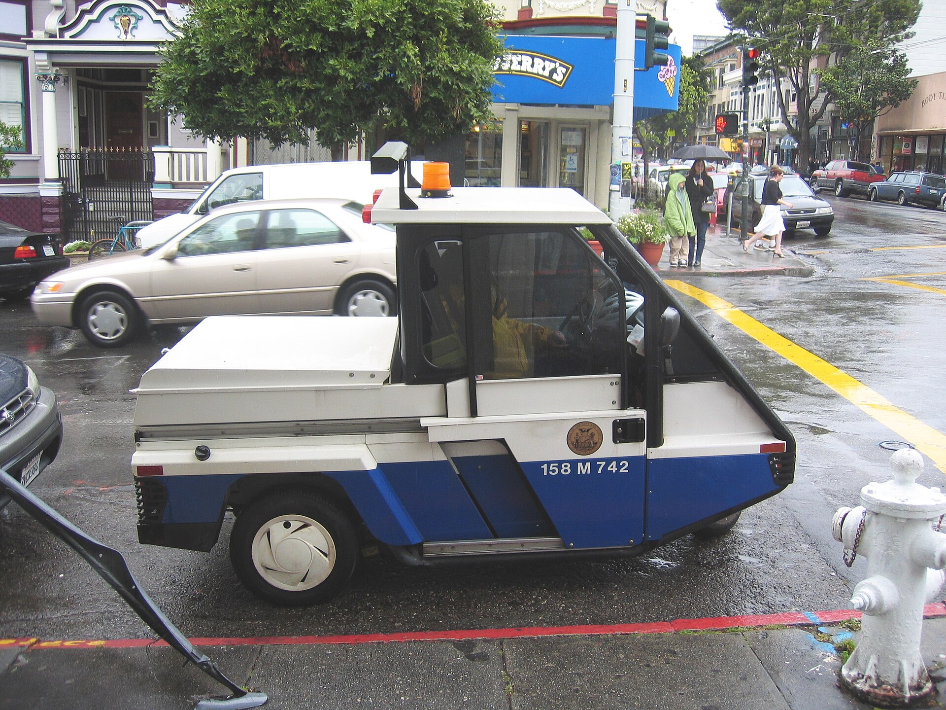 A municipal parking enforcement vehicle operating on a city street