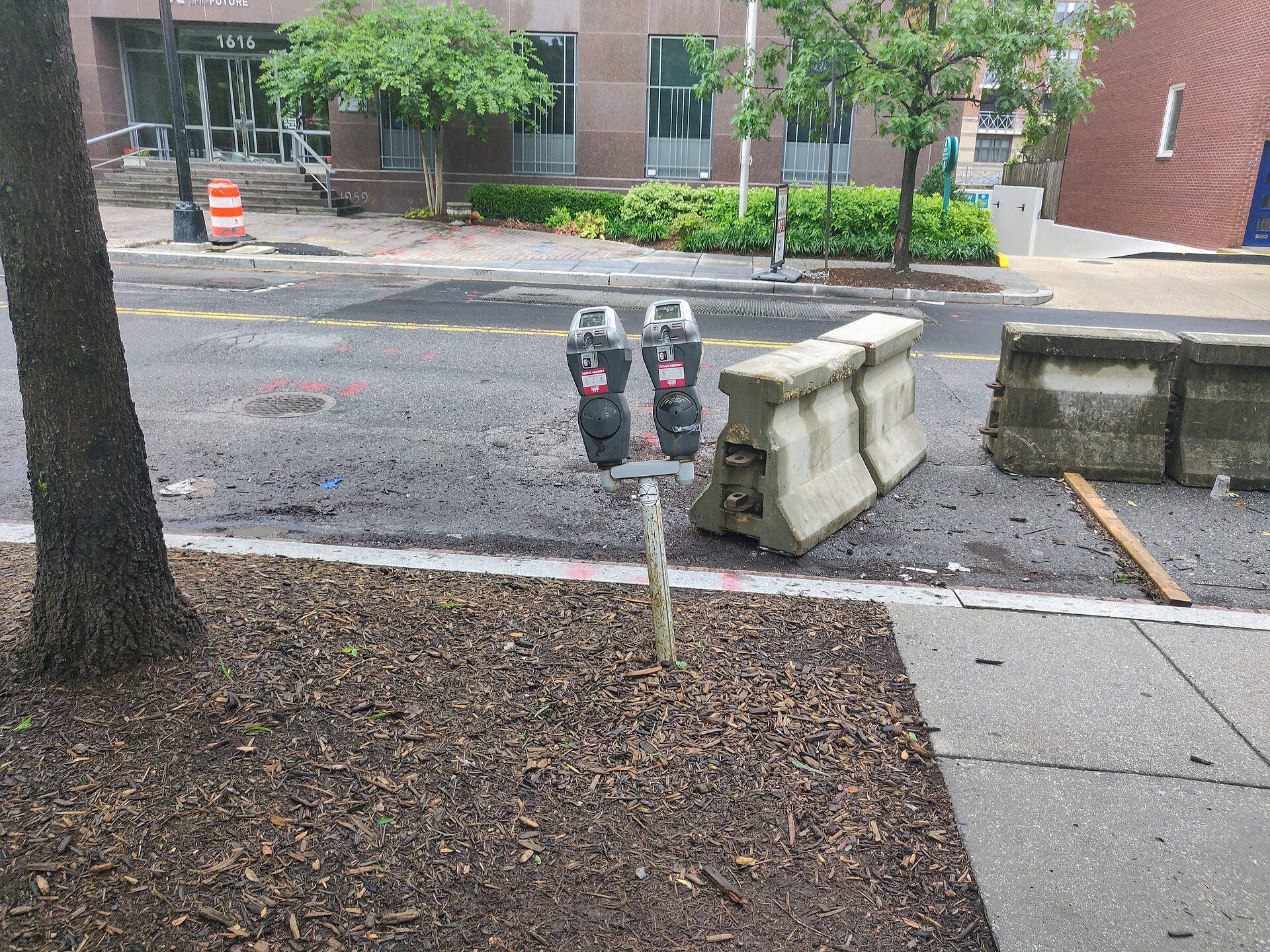 A modern parking meter beside an urban curb